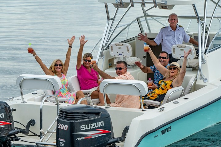 a group of people riding on the back of a boat