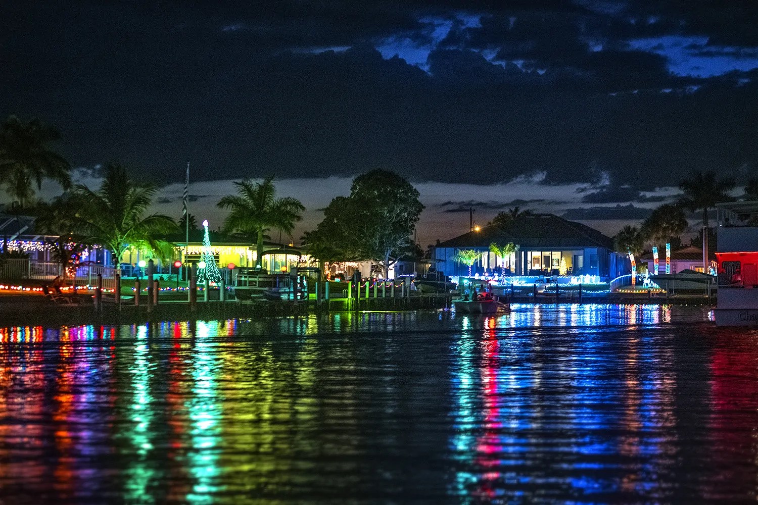 a body of water with a city in the night sky