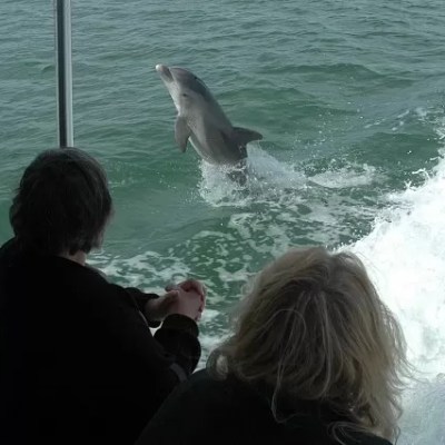a group of people standing in front of a body of water