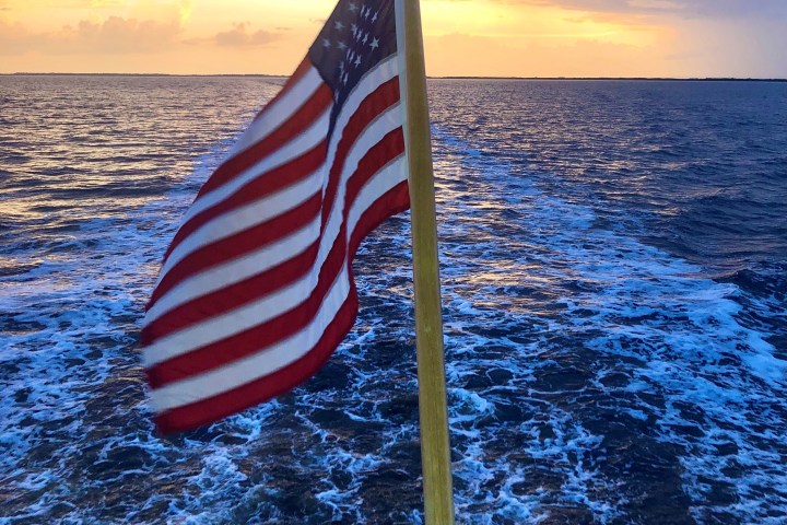 a flag next to a body of water